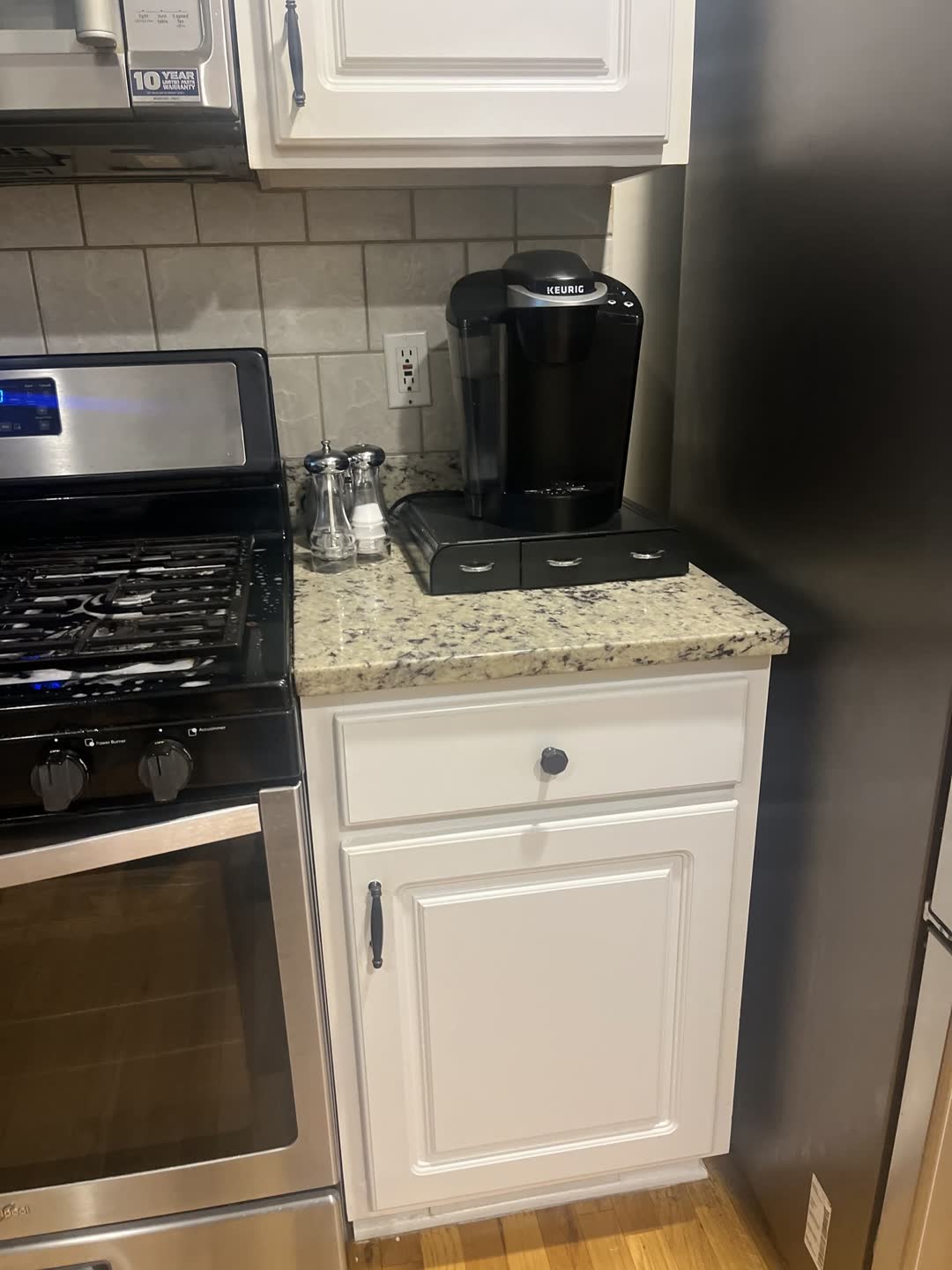 After photo: clean kitchen range, cabinets and granite counters from a Clean Slate job in Stone Mountain, GA