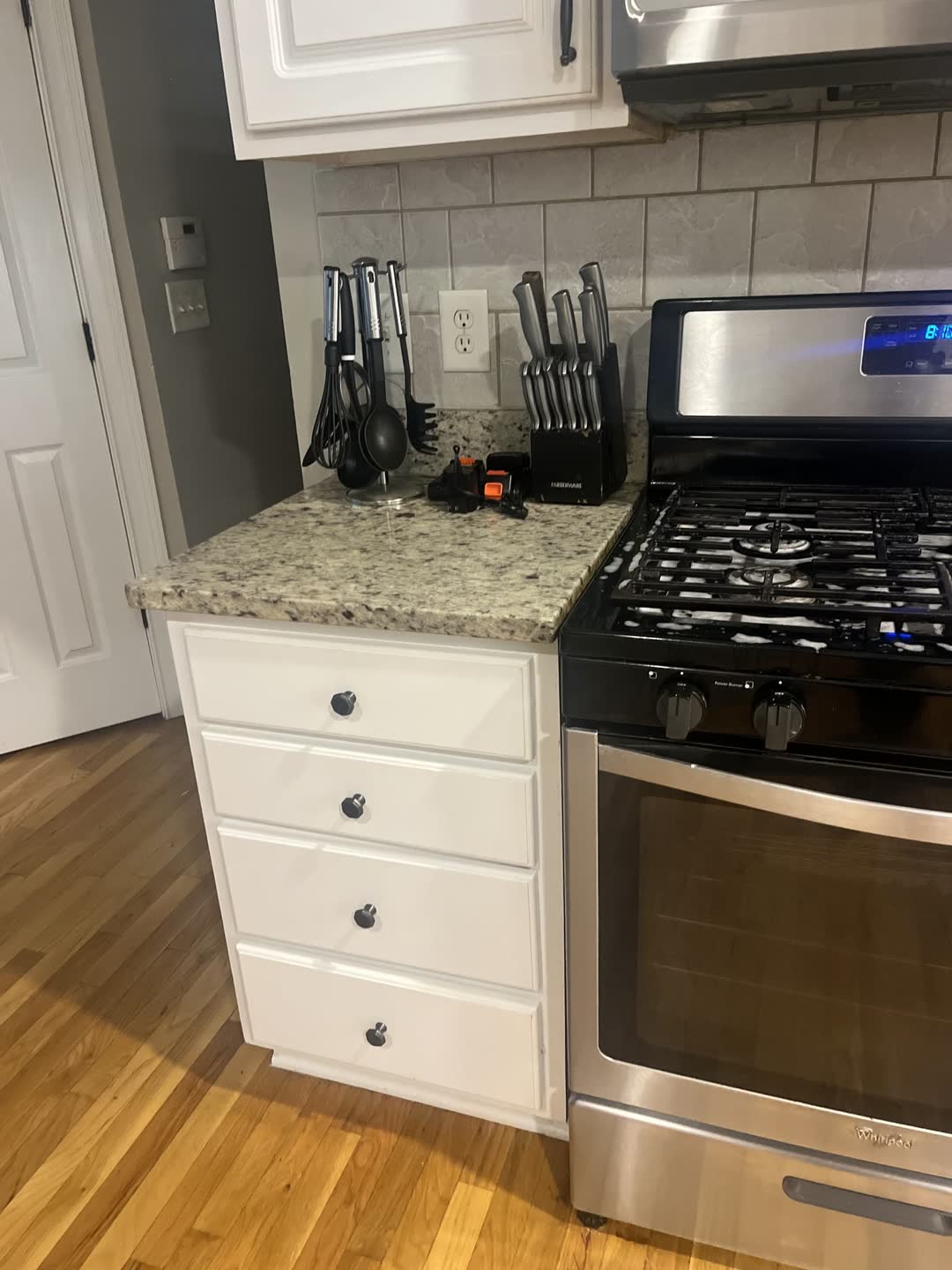 After photo: clean kitchen range, cabinets and granite counters from a Clean Slate job in Stone Mountain, GA