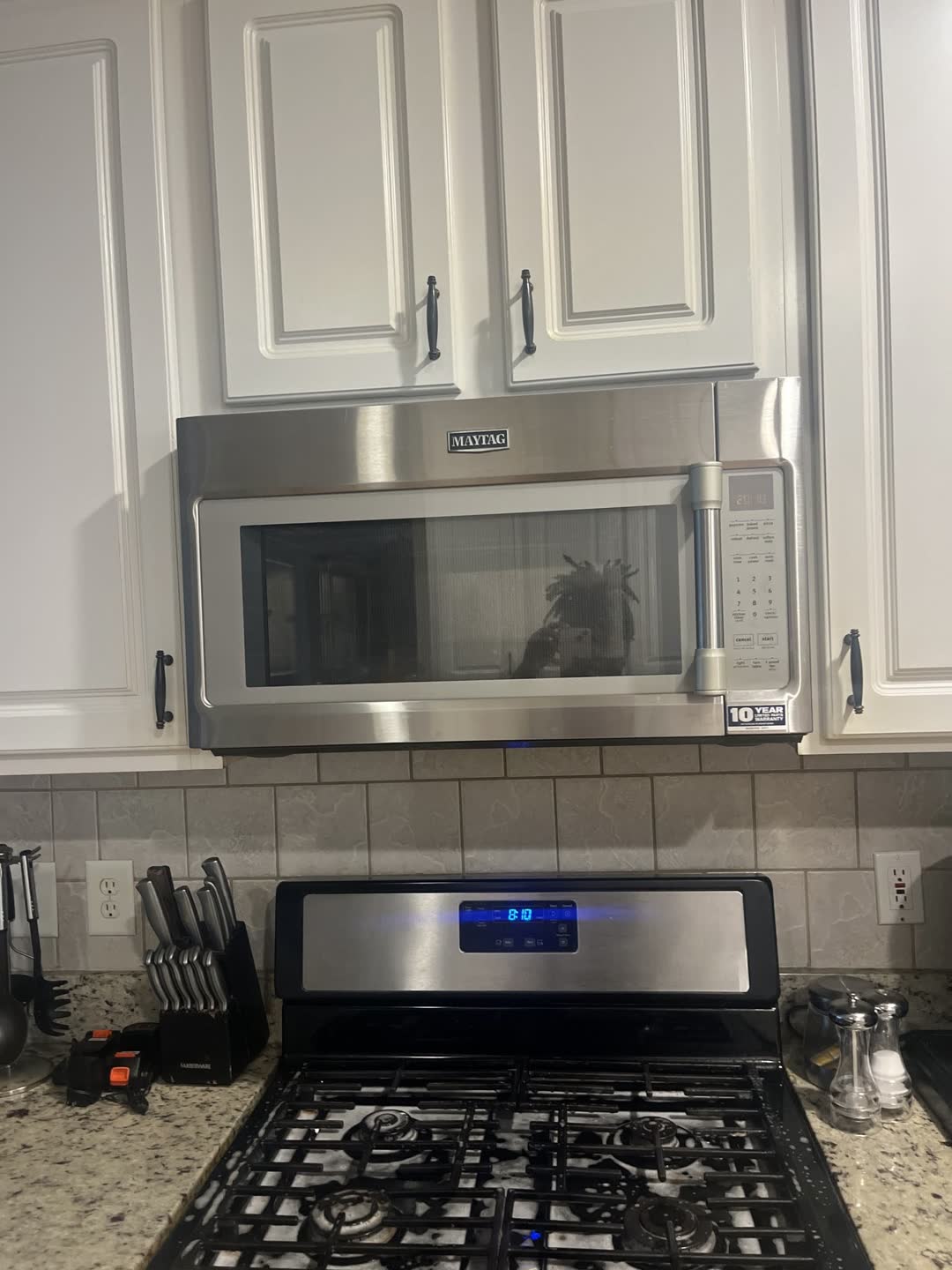 After photo: clean kitchen range, cabinets and granite counters from a Clean Slate job in Stone Mountain, GA
