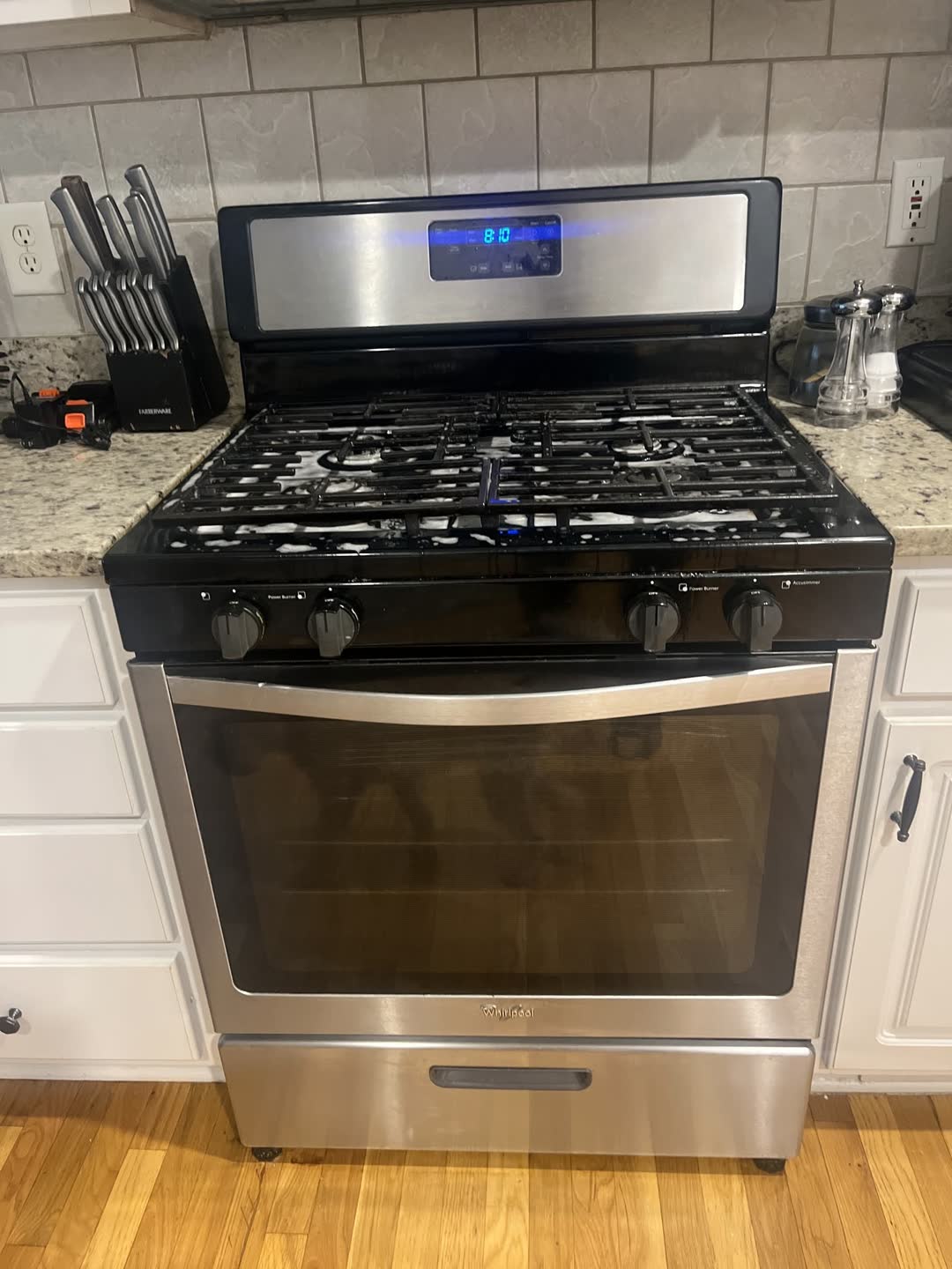 After photo: clean kitchen range, cabinets and granite counters from a Clean Slate job in Stone Mountain, GA
